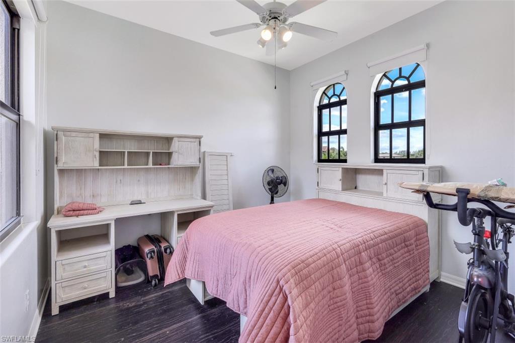 1276 Kendari Terrace Naples, FL 34113 - Photo 22 of 31 a bedroom with a bed and a chandelier