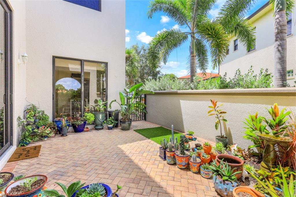 1276 Kendari Terrace Naples, FL 34113 - Photo 27 of 31 a front view of a house with a garden