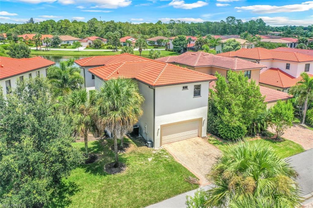 1276 Kendari Terrace Naples, FL 34113 - Photo 28 of 31 an aerial view of a house with yard and green space