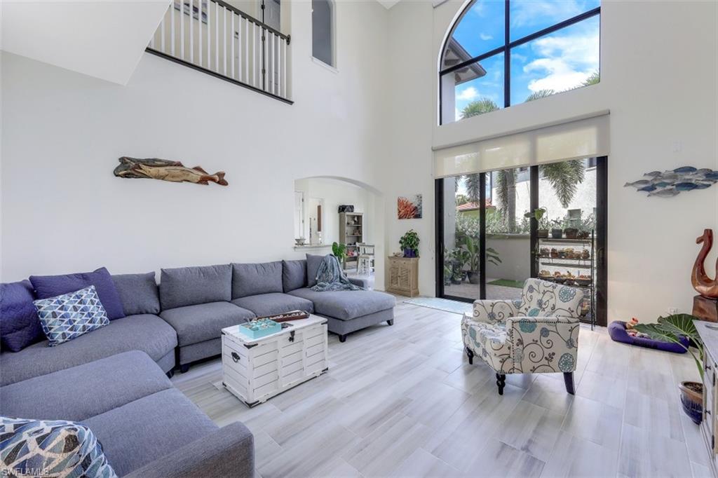 1276 Kendari Terrace Naples, FL 34113 - Photo 8 of 31 a living room with furniture and a table