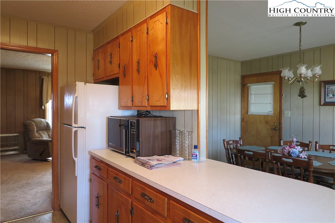 134 Carson Boulevard Sparta, NC 28675 - Photo 5 of 15 a bedroom with a bed and a chandelier