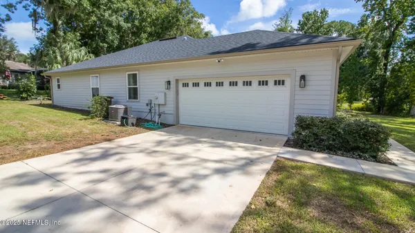 a view of a house with backyard and sitting area