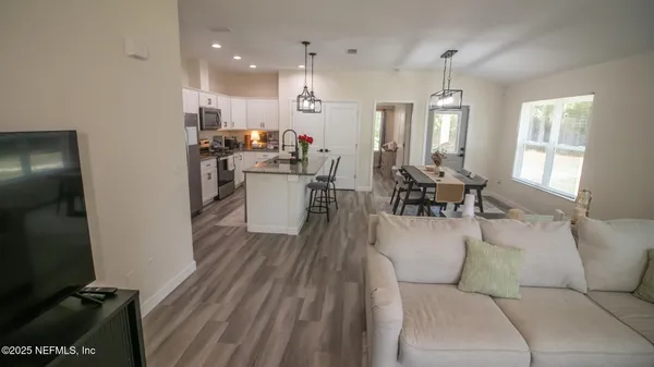 a view of a kitchen with sink and dishwasher wooden floor
