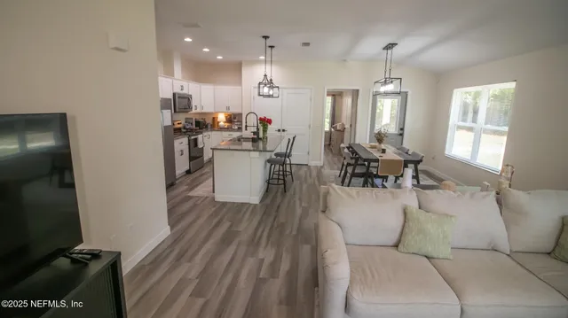 a view of a kitchen with sink and dishwasher wooden floor