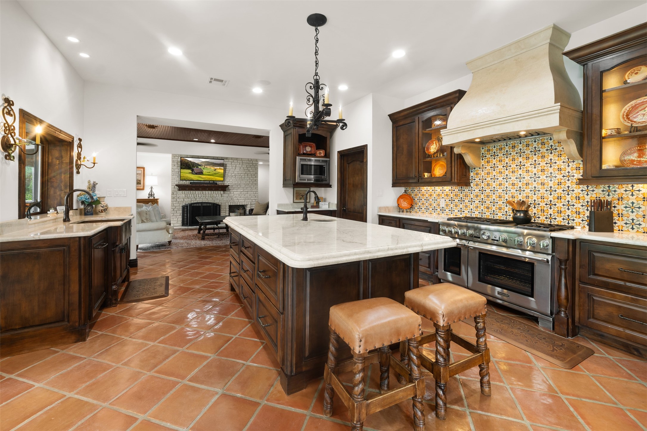 34000 Smithson Valley Road Bulverde, TX 78163 - Photo 6 of 50 The chef's kitchen blends elegance and function with custom cabinetry, artisan tilework, premium appliances, and an oversized center island. Rich finishes and thoughtful design make it the heart of the home.