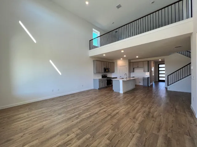 a kitchen with a sink cabinets and wooden floor