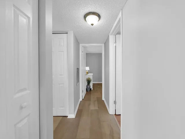 a view of a hallway with wooden floor