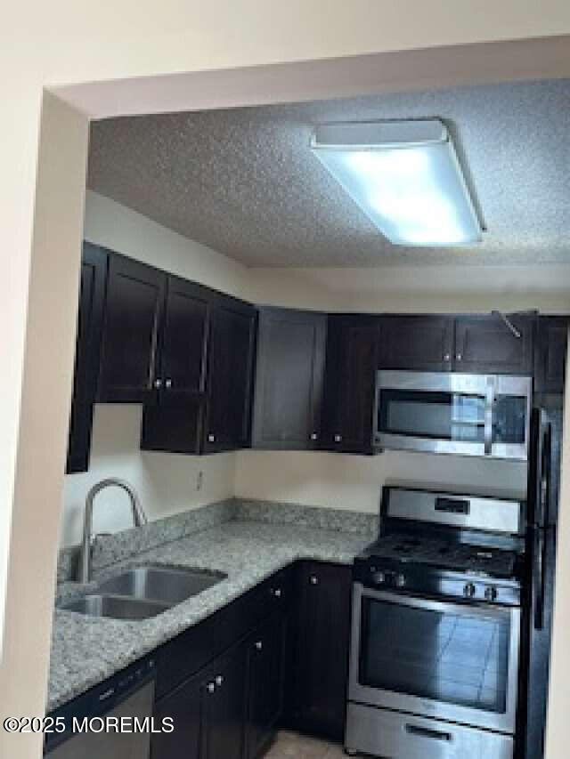 702 Goldthread Court Jackson, NJ 08527 - Photo 12 of 20 a kitchen with granite countertop a stove and a sink