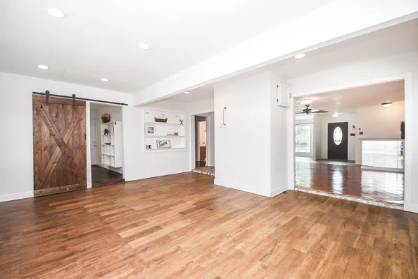a view of empty room with wooden floor