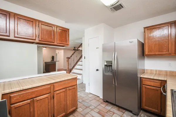 a kitchen with stainless steel appliances granite countertop a refrigerator a sink and dishwasher