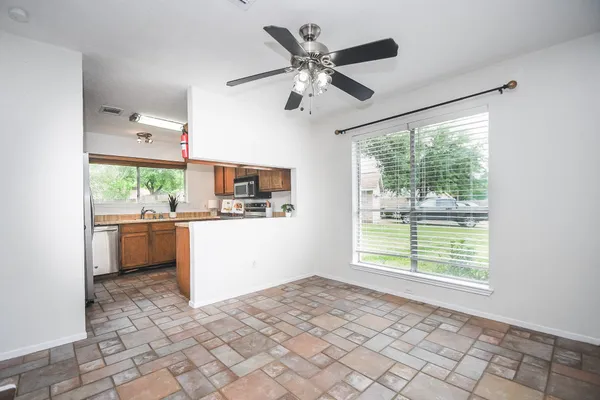 a room with a ceiling fan and a window
