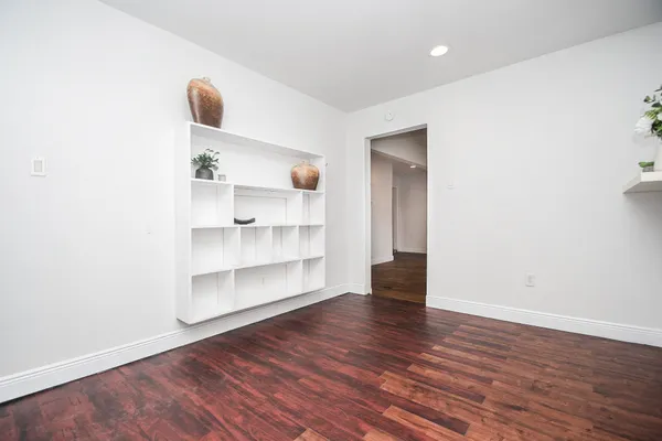 an empty room with wooden floor