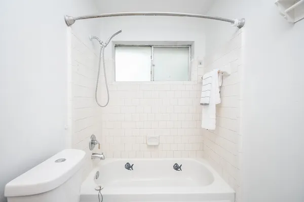 a bathroom with a bathtub a toilet and a sink