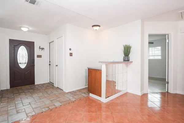 a view of a hallway to rooms