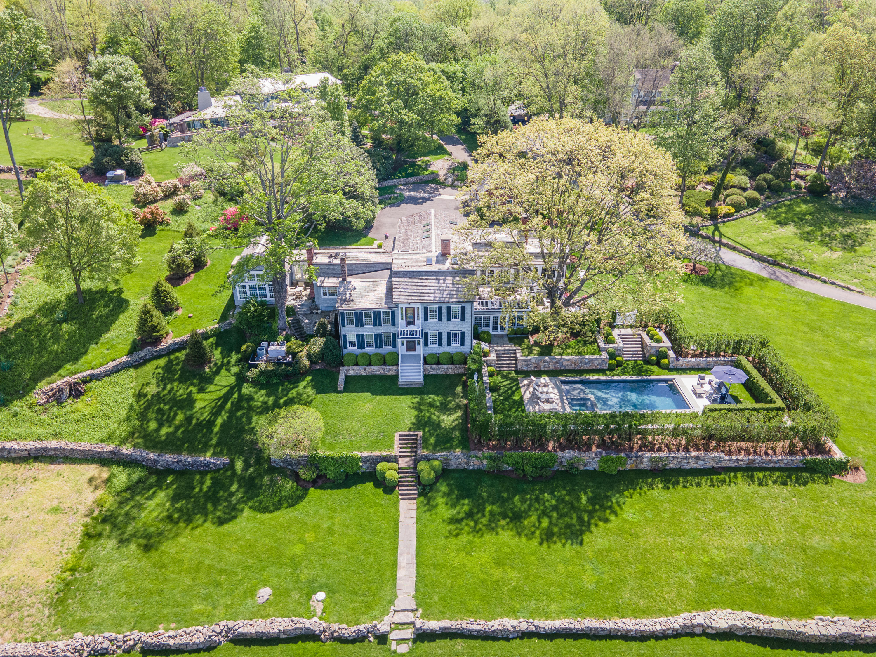 118 Goodwives River Road Darien, CT 06820 - Photo 1 of 68 a view of a swimming pool with a garden