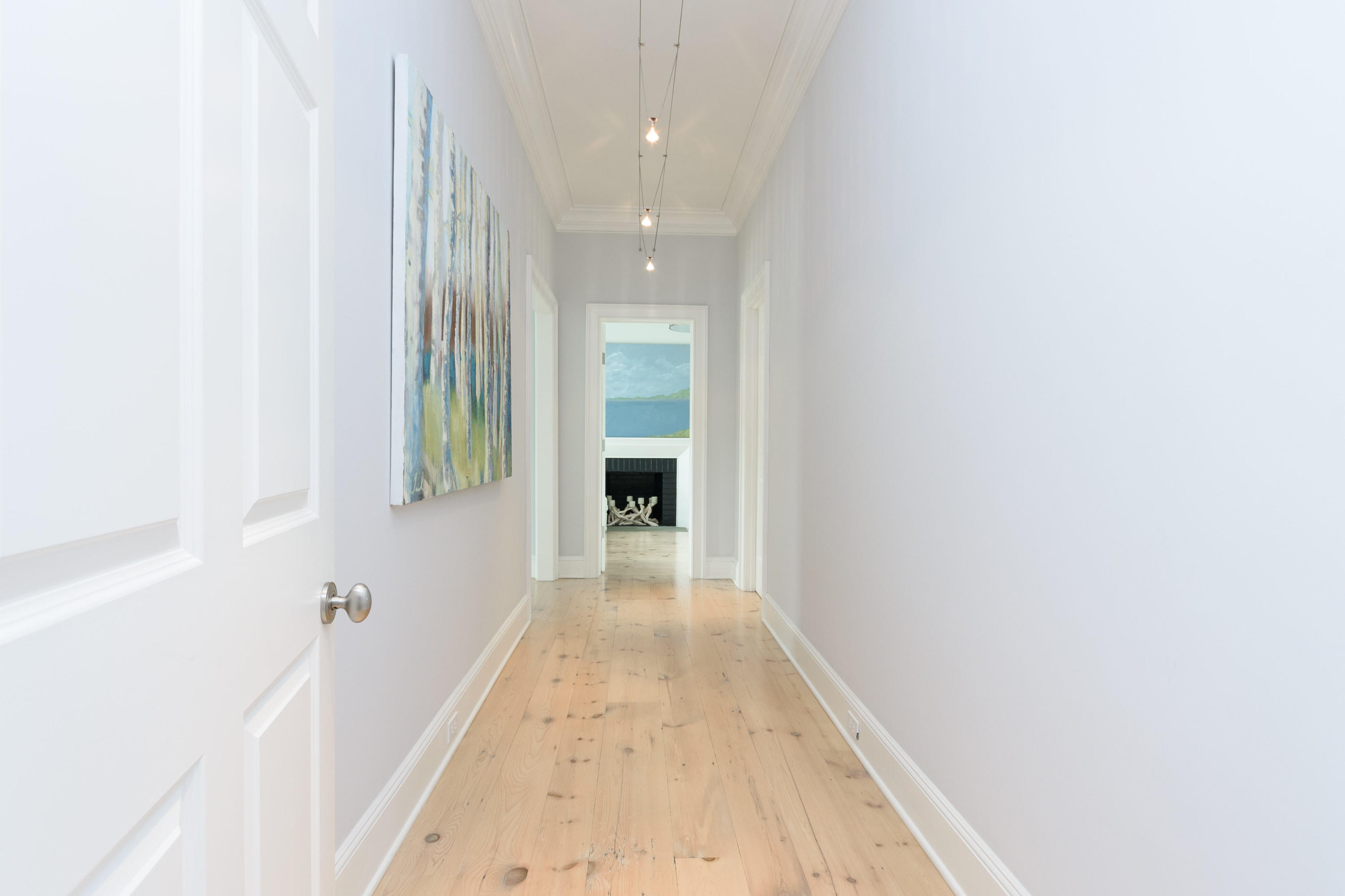 118 Goodwives River Road Darien, CT 06820 - Photo 23 of 68 a view of a hallway with wooden floor and a bathroom