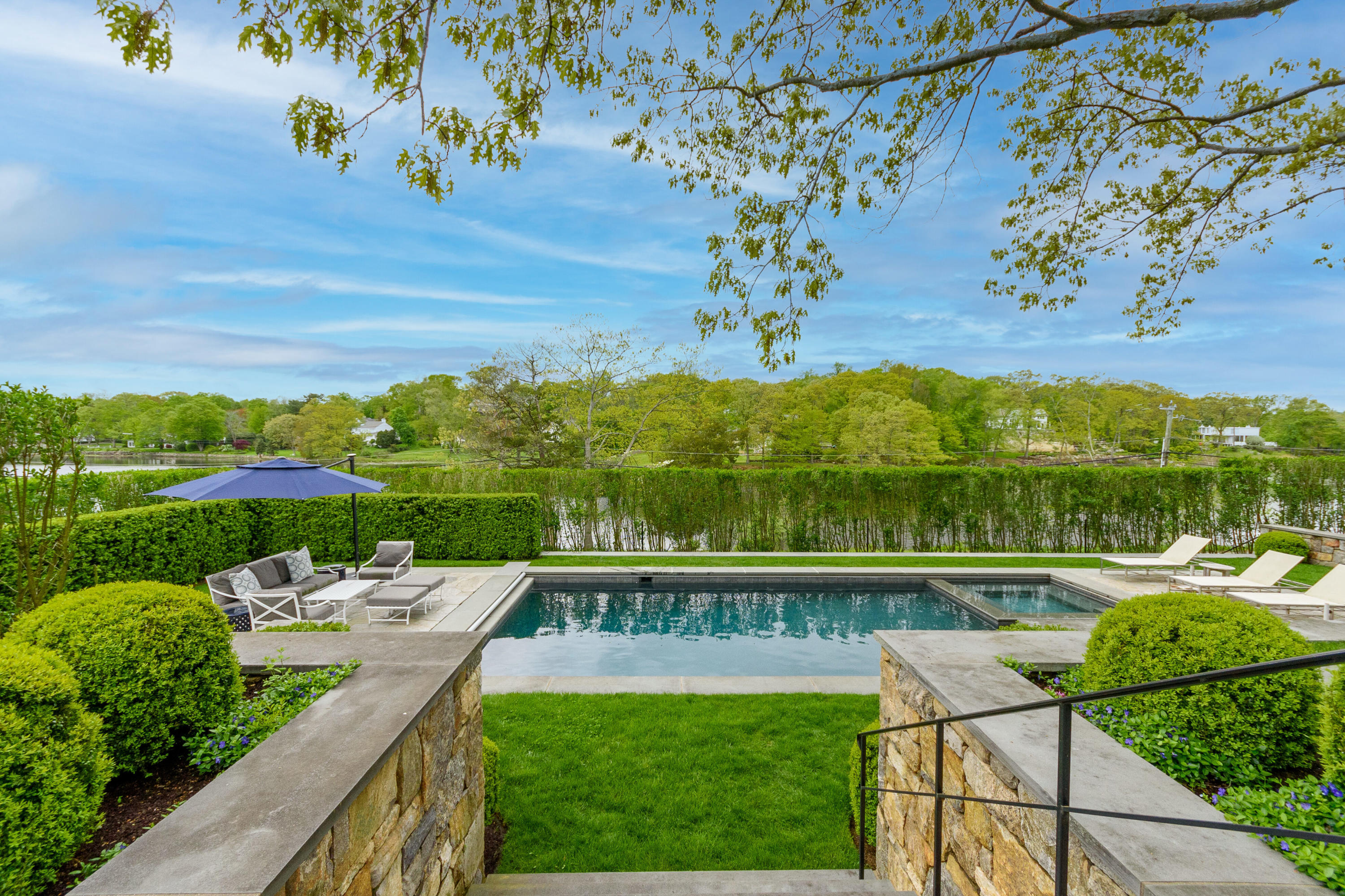 118 Goodwives River Road Darien, CT 06820 - Photo 47 of 68 a view of a swimming pool with a patio