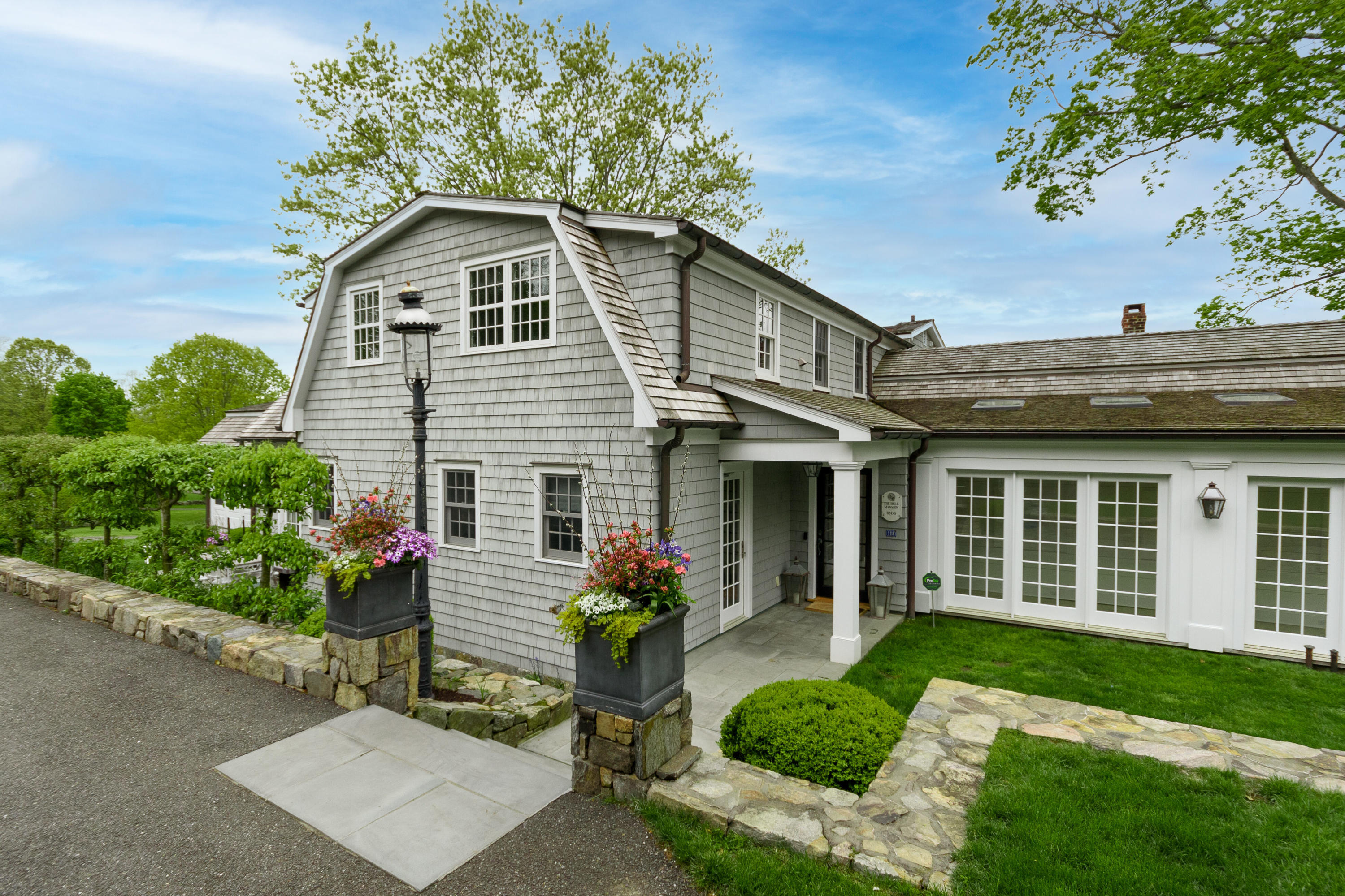 118 Goodwives River Road Darien, CT 06820 - Photo 6 of 68 a view of a house with a yard and potted plants
