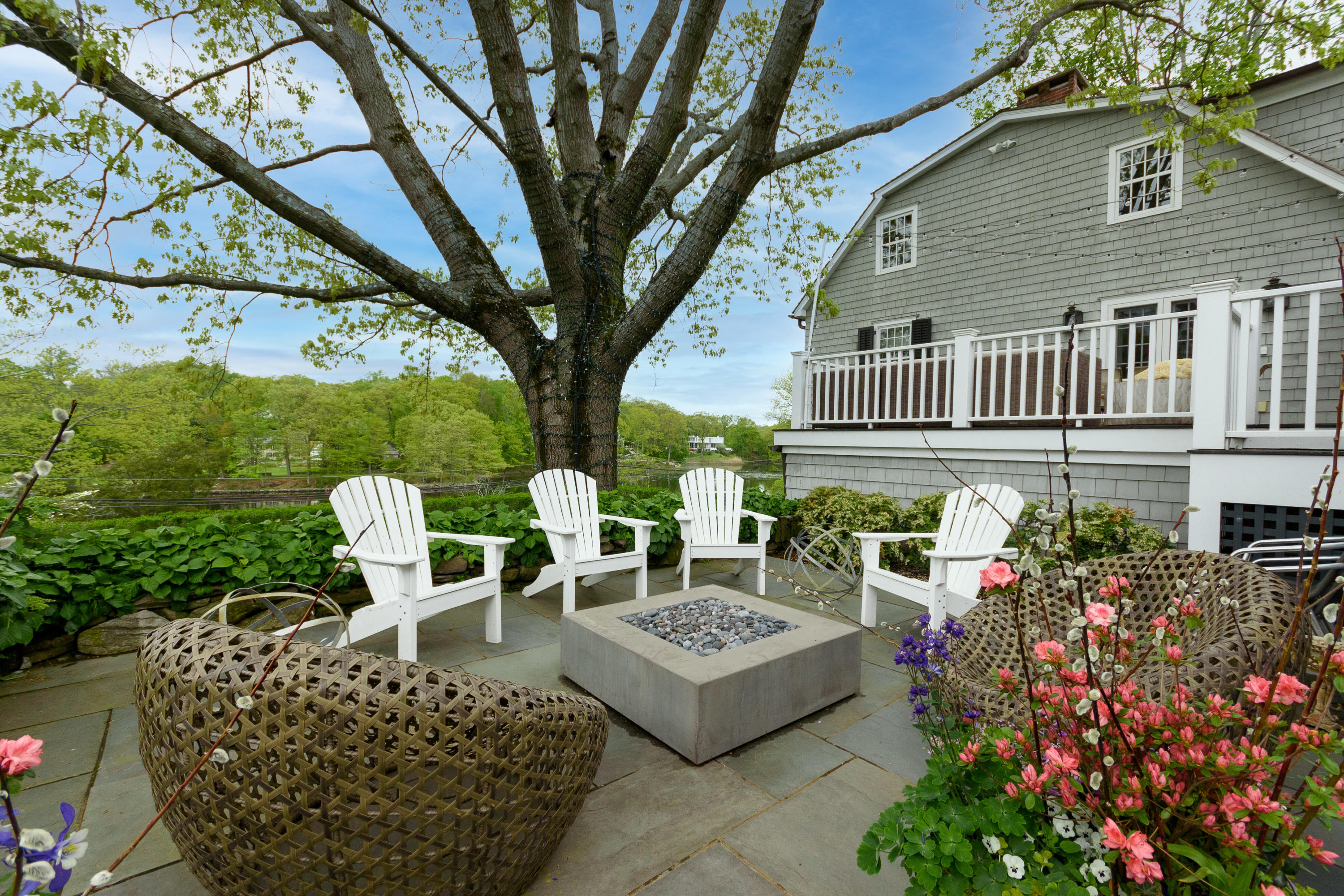 118 Goodwives River Road Darien, CT 06820 - Photo 60 of 68 a view of a chairs and table in the backyard
