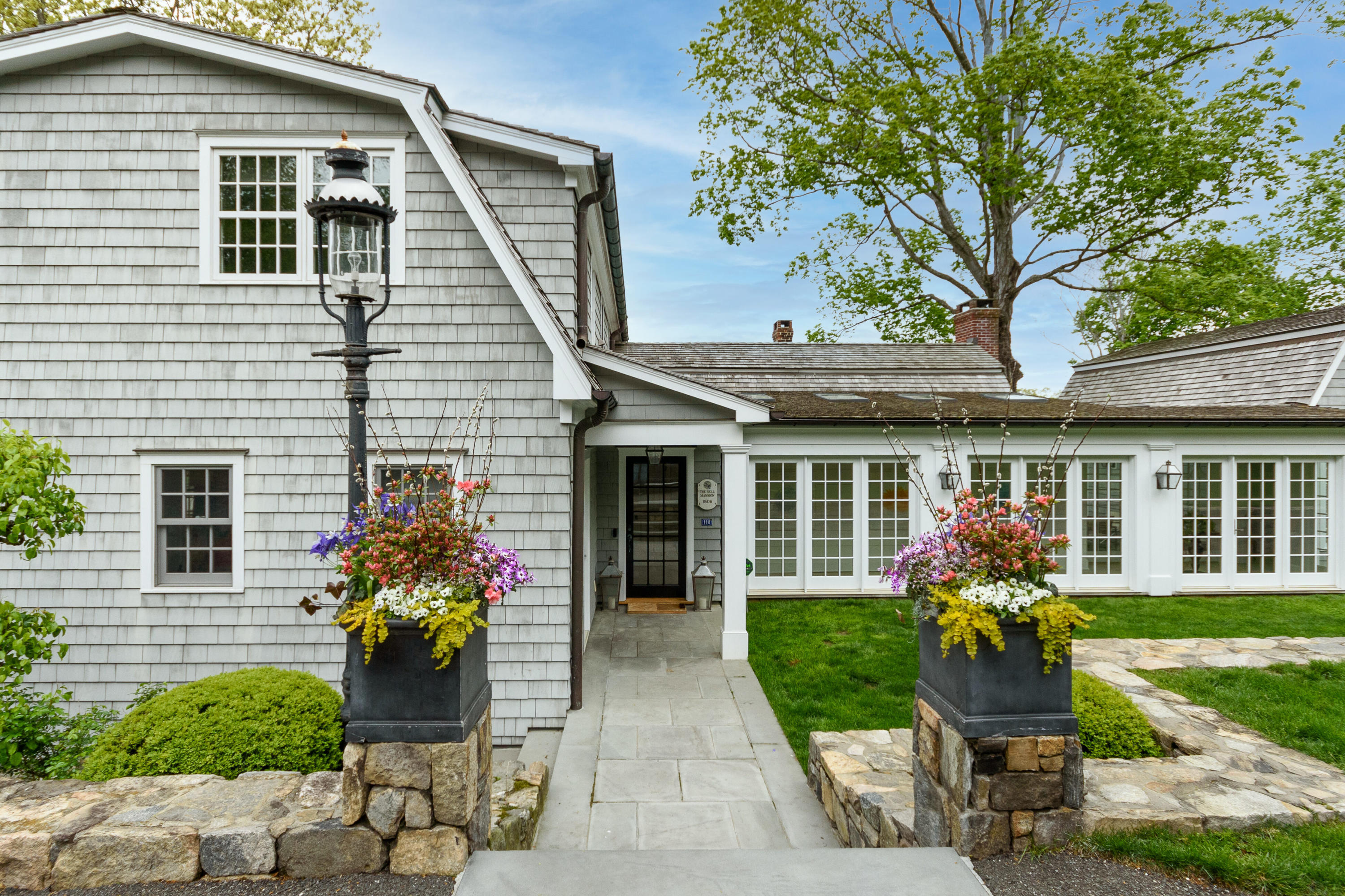118 Goodwives River Road Darien, CT 06820 - Photo 7 of 68 a front view of a house with garden