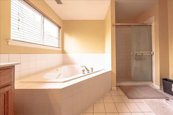 a bathroom with a bathtub and a shower