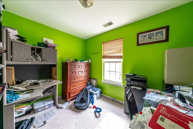 a bedroom with a workspace