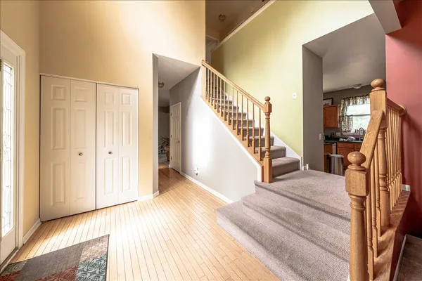 a view of a livingroom with wooden floor and stairs