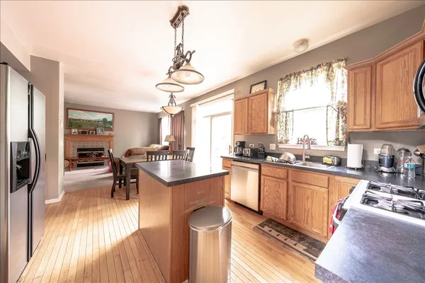 a kitchen with stainless steel appliances granite countertop sink stove top oven and cabinets