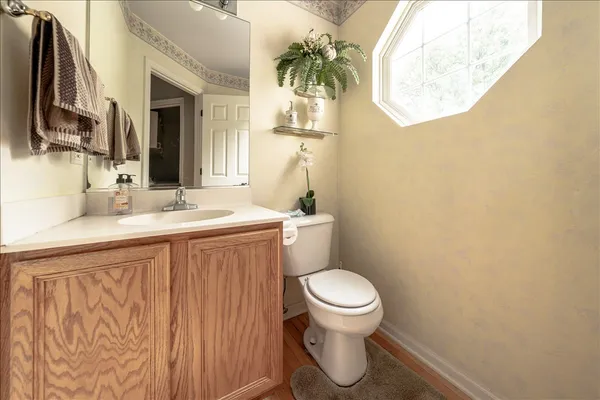 a bathroom with a sink a toilet and a mirror