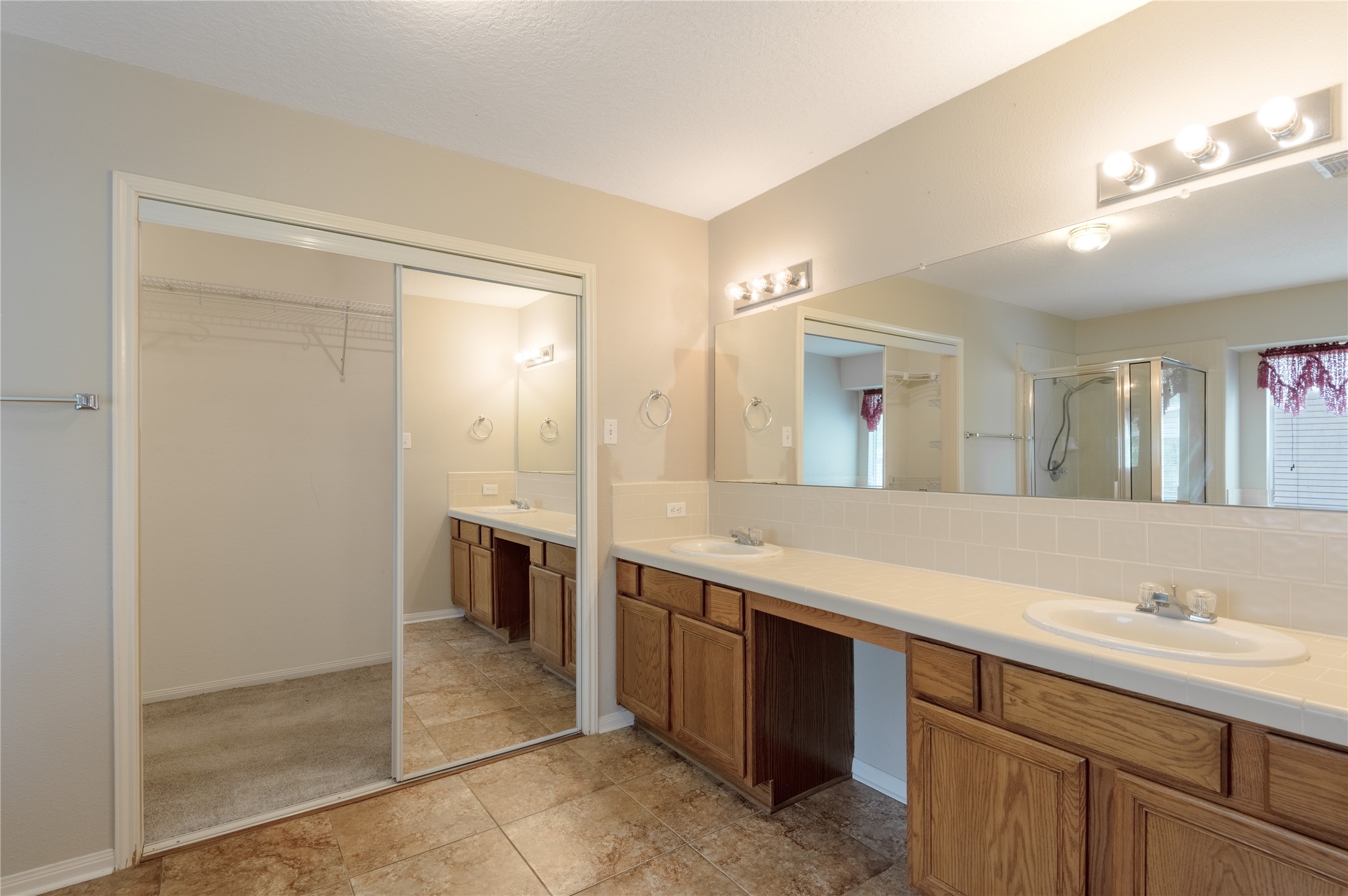 324 Red Oak Lane Trinity, TX 75862 - Photo 27 of 49 a spacious bathroom with a shower a sink and a mirror