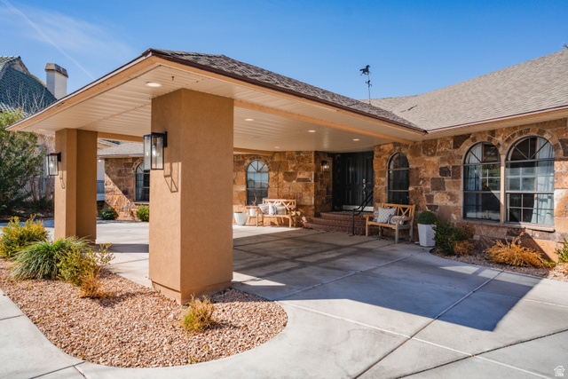 980 Cactus Circle St. George, UT 84790 - Photo 71 of 77 Doorway to property with stone siding and a shingled roof