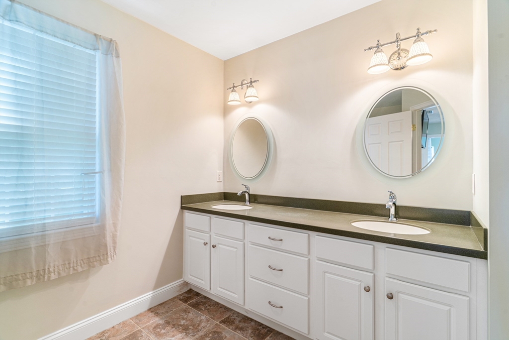 53 Baldwin Road, Unit 1201 Billerica, MA 01821 - Photo 18 of 36 a bathroom with a sink and a mirror