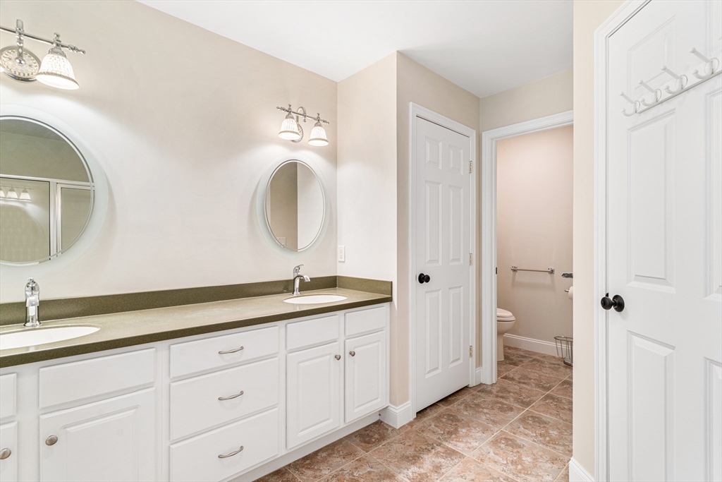 53 Baldwin Road, Unit 1201 Billerica, MA 01821 - Photo 19 of 36 a spacious bathroom with a granite countertop sink a mirror and a