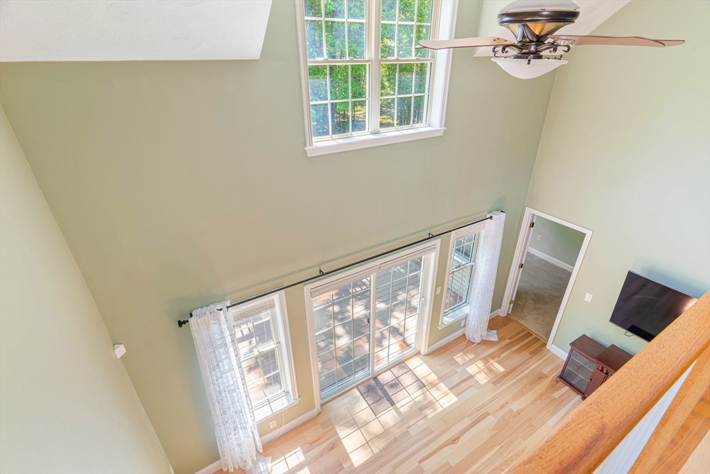 53 Baldwin Road, Unit 1201 Billerica, MA 01821 - Photo 23 of 36 a view of a livingroom with wooden floor and a flat screen tv
