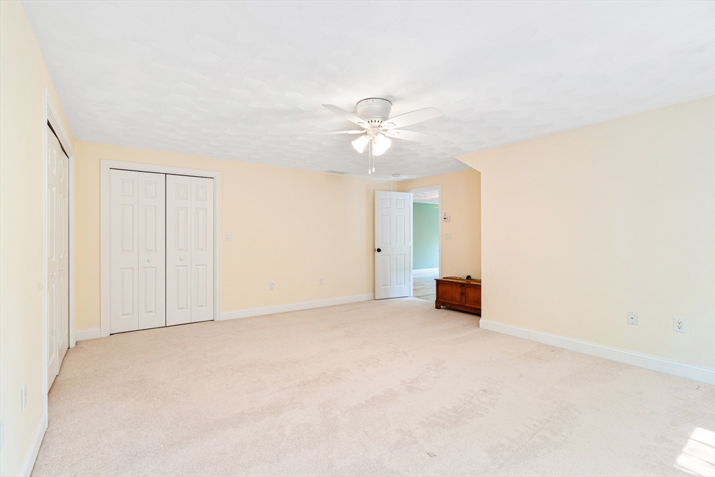 53 Baldwin Road, Unit 1201 Billerica, MA 01821 - Photo 25 of 36 an empty room with a ceiling fan and a window