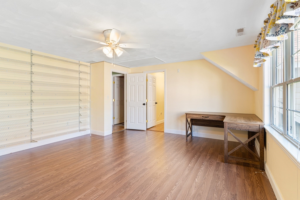 53 Baldwin Road, Unit 1201 Billerica, MA 01821 - Photo 28 of 36 a view of a livingroom with wooden floor and a ceiling fan
