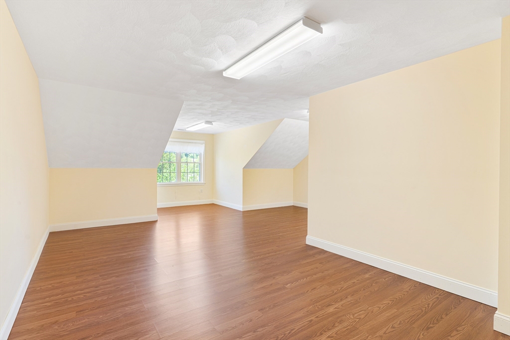 53 Baldwin Road, Unit 1201 Billerica, MA 01821 - Photo 31 of 36 a view of an empty room with wooden floor and a window
