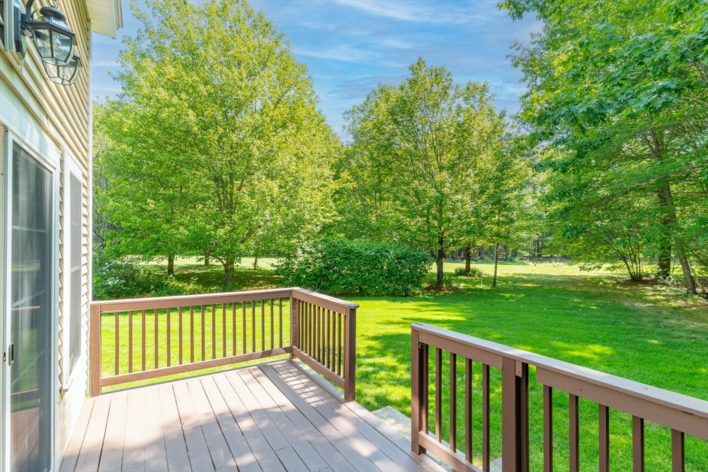 53 Baldwin Road, Unit 1201 Billerica, MA 01821 - Photo 36 of 36 a view of a wooden deck and a yard with wooden fence