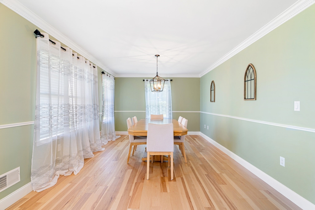 53 Baldwin Road, Unit 1201 Billerica, MA 01821 - Photo 5 of 36 a dining room with wooden floor and windows