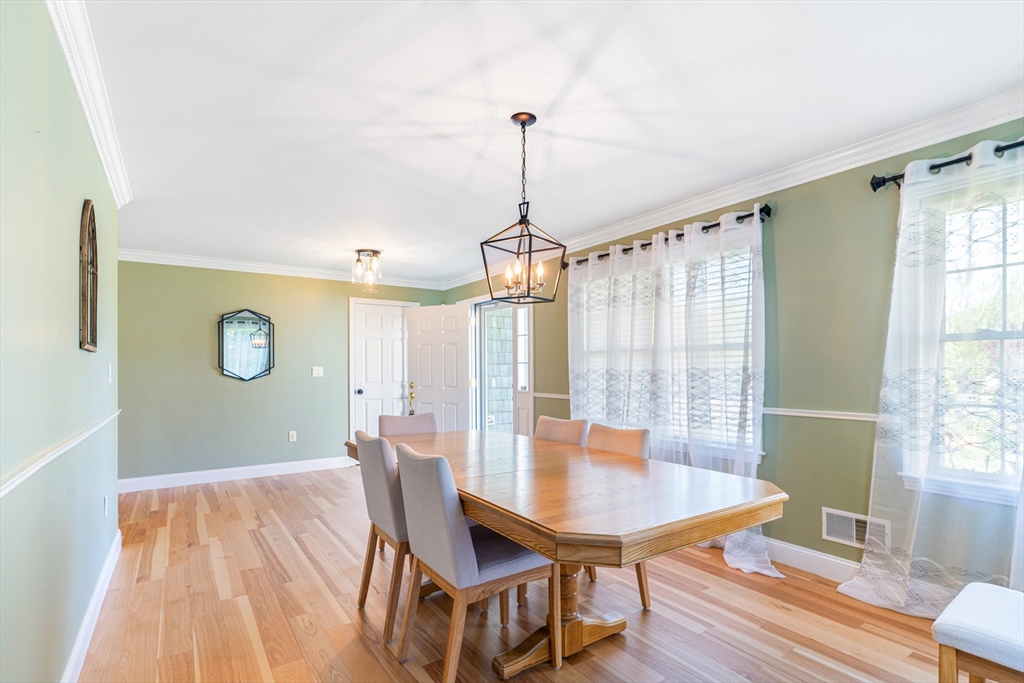 53 Baldwin Road, Unit 1201 Billerica, MA 01821 - Photo 7 of 36 a dining room with furniture window and wooden floor