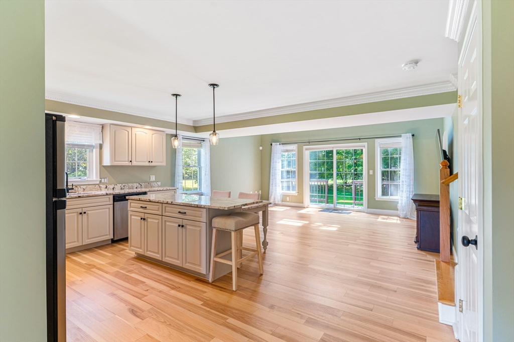 53 Baldwin Road, Unit 1201 Billerica, MA 01821 - Photo 8 of 36 a large kitchen with kitchen island a large counter space a sink appliances and cabinets