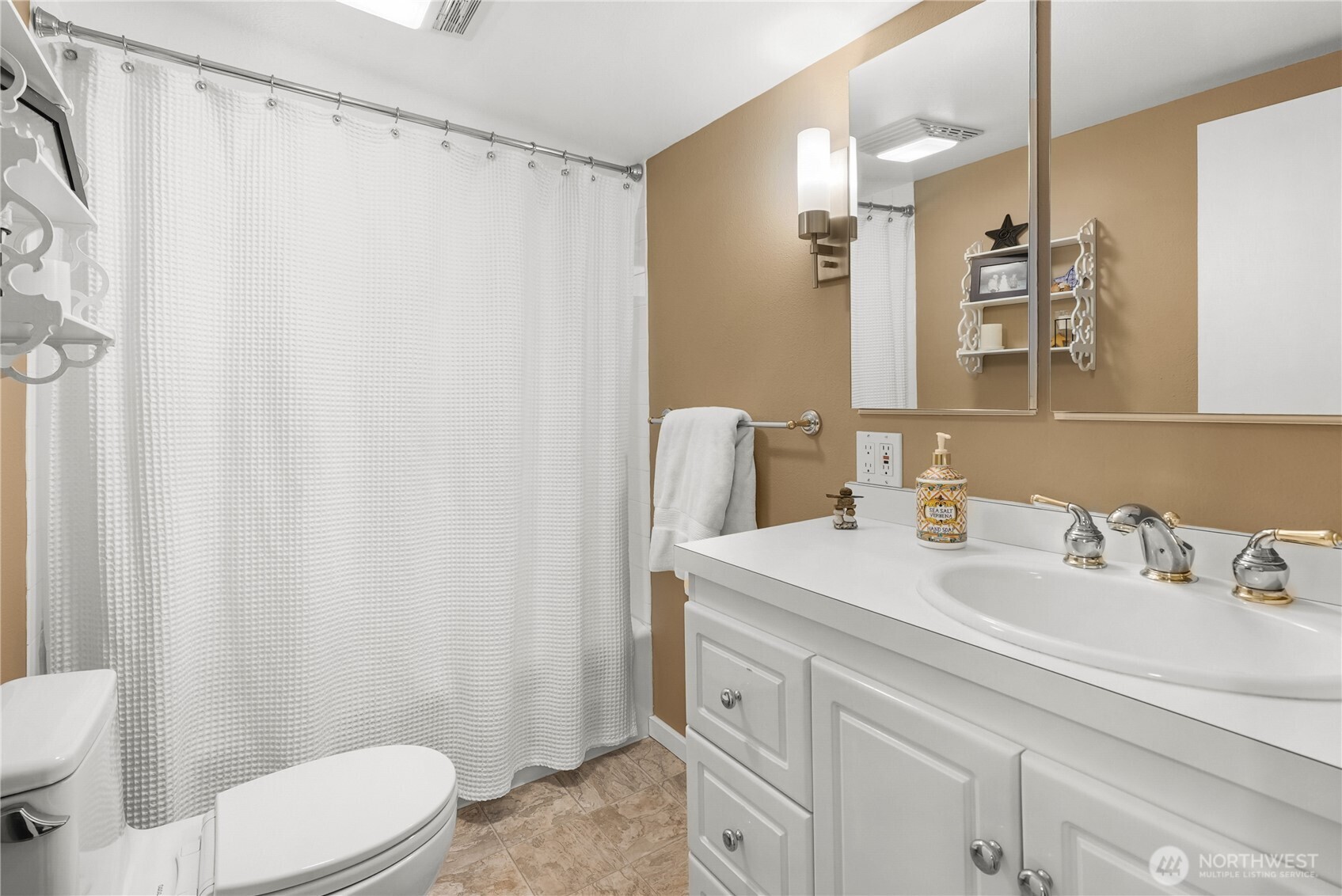 29 Northwest Lake Roesiger Road Snohomish, WA 98290 - Photo 16 of 38 a bathroom with a sink a toilet a mirror and shower curtain