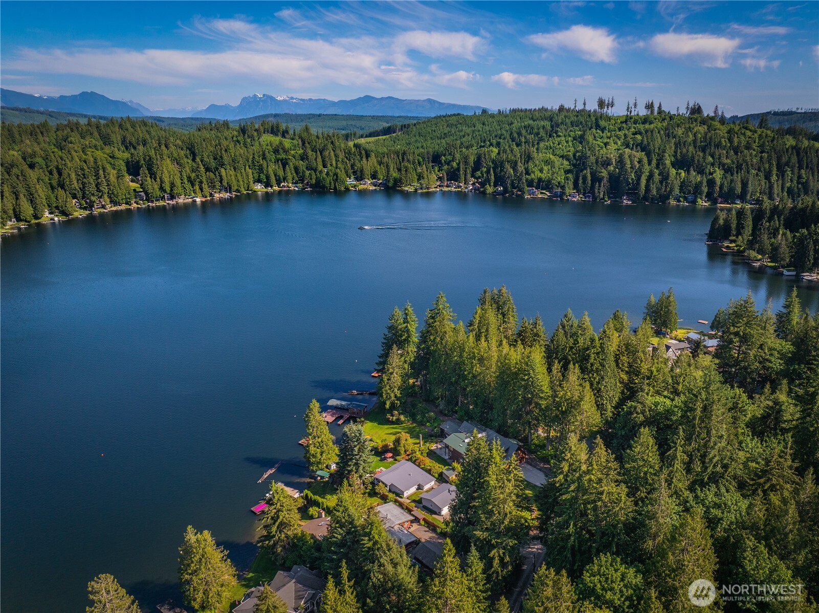 29 Northwest Lake Roesiger Road Snohomish, WA 98290 - Photo 2 of 38 a view of a lake with a building in the background