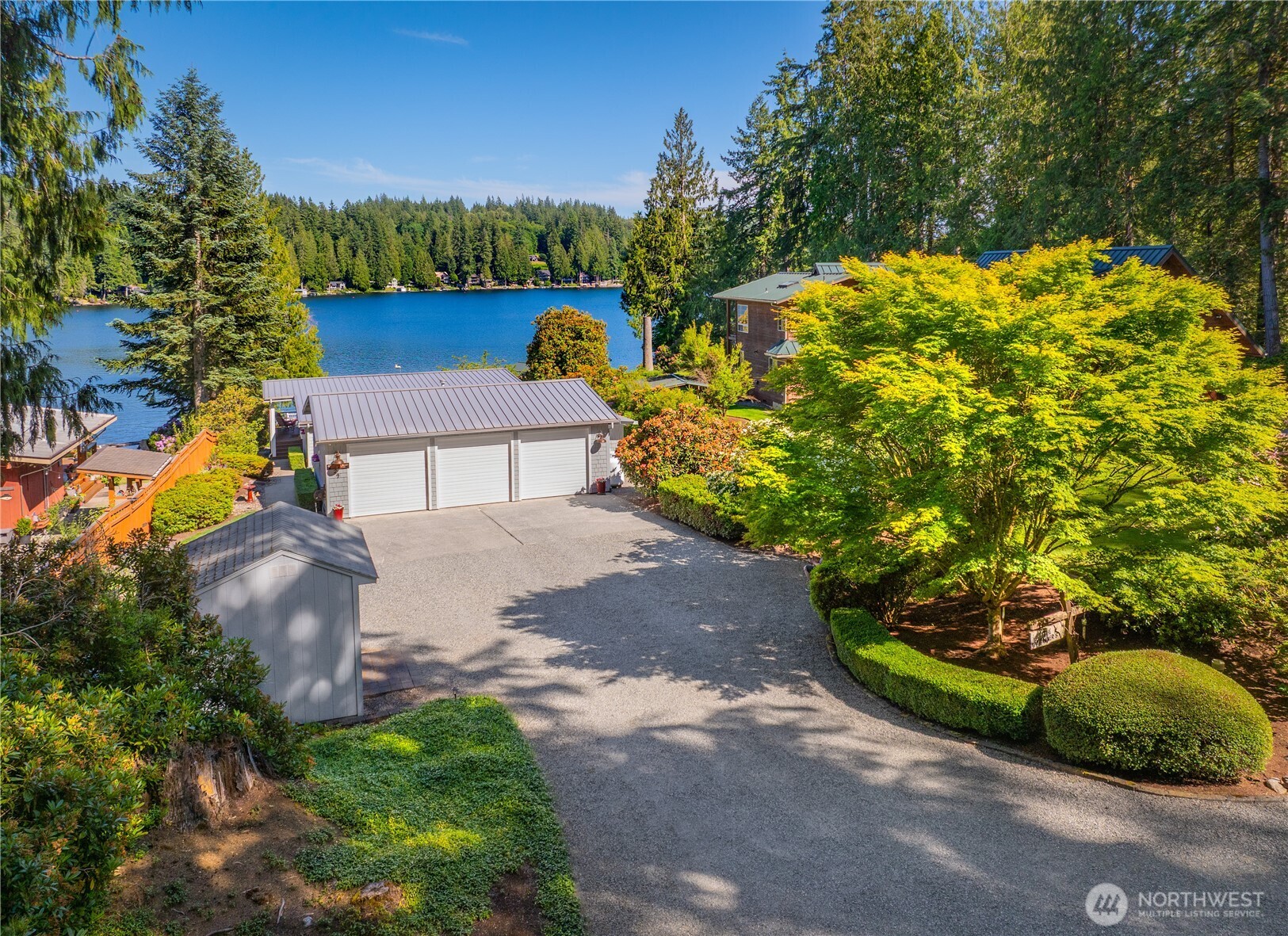 29 Northwest Lake Roesiger Road Snohomish, WA 98290 - Photo 5 of 38 a view of a yard with plants and a bench