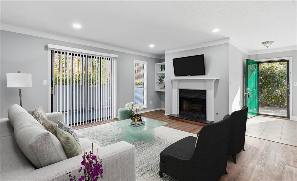 601 Wynnes Ridge Circle Southeast Marietta, GA 30067 - Photo 1 of 28 a living room with furniture a flat screen tv and a fireplace
