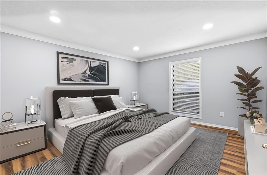 601 Wynnes Ridge Circle Southeast Marietta, GA 30067 - Photo 15 of 28 a bedroom with a large bed and a couch