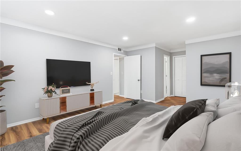 601 Wynnes Ridge Circle Southeast Marietta, GA 30067 - Photo 17 of 28 a bedroom with a bed and a flat tv screen on wall