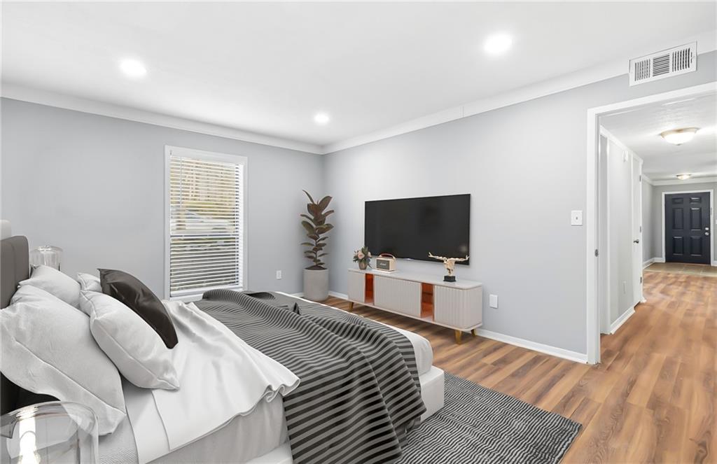 601 Wynnes Ridge Circle Southeast Marietta, GA 30067 - Photo 18 of 28 a bedroom with a bed and a flat screen tv