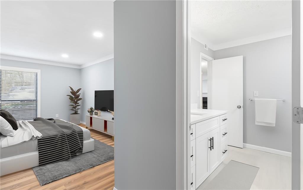 601 Wynnes Ridge Circle Southeast Marietta, GA 30067 - Photo 19 of 28 a bedroom with furniture and a flat screen tv