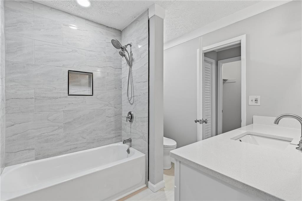 601 Wynnes Ridge Circle Southeast Marietta, GA 30067 - Photo 21 of 28 a bathroom with a sink a mirror and a bathtub